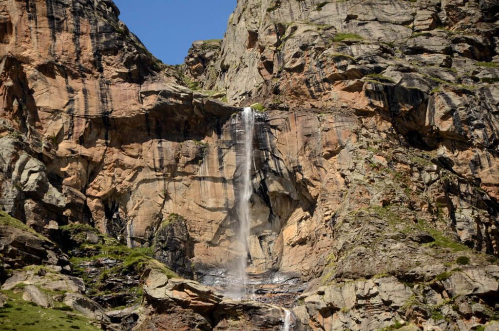 A waterfall plunging down the rocky mountain walls. Kinnaur and Spiti road trip.