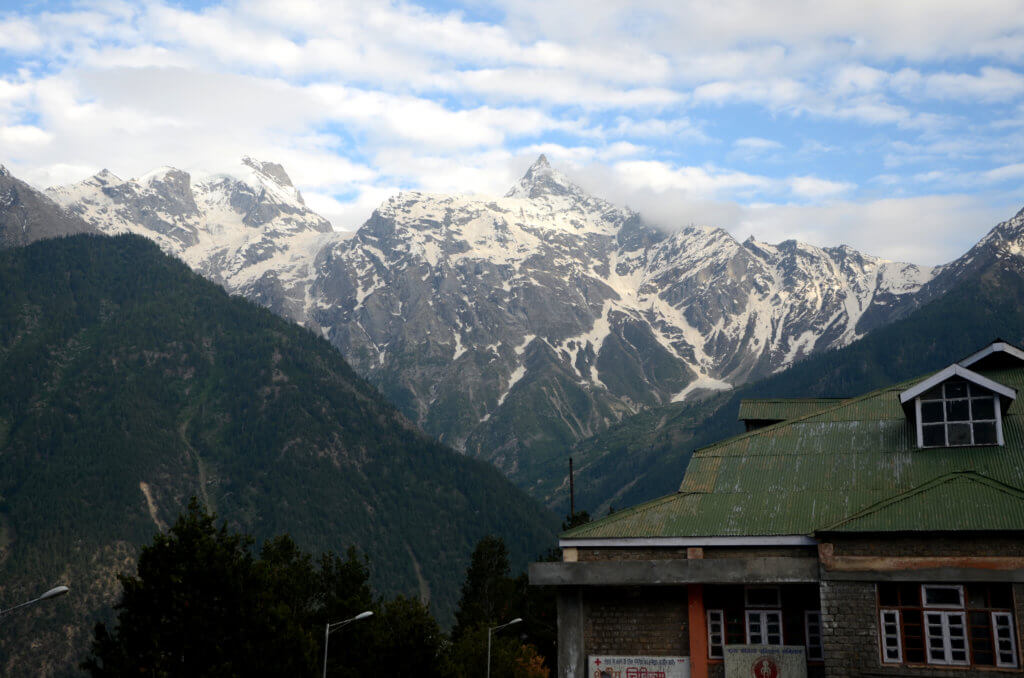 Snow-capped mountains forming the backdrop of a small village in Kinnaur district - Chini.