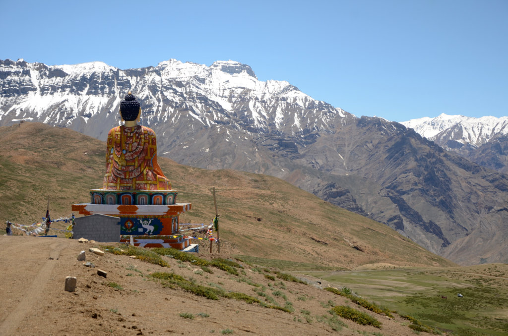 Large statue of Lord Buddha overlooking the mountain valley in Langza, Spiti.