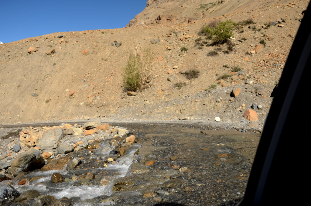 Kaza-Manali road. Snow melted water from the glaciers gushed from the mountain tops, and rippled across our rock-laden roadway. Kinnaur and Spiti road trip.
