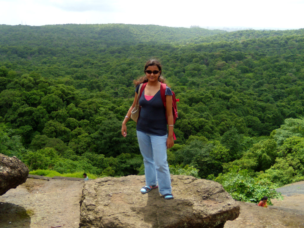 Pubali at the Kanheri Caves in Sanjay Gandhi National Park, right in the middle of the bustling Mumbai city. Seen in the photo: widespread vistas of green canopy seen from the top of Kanheri Caves.