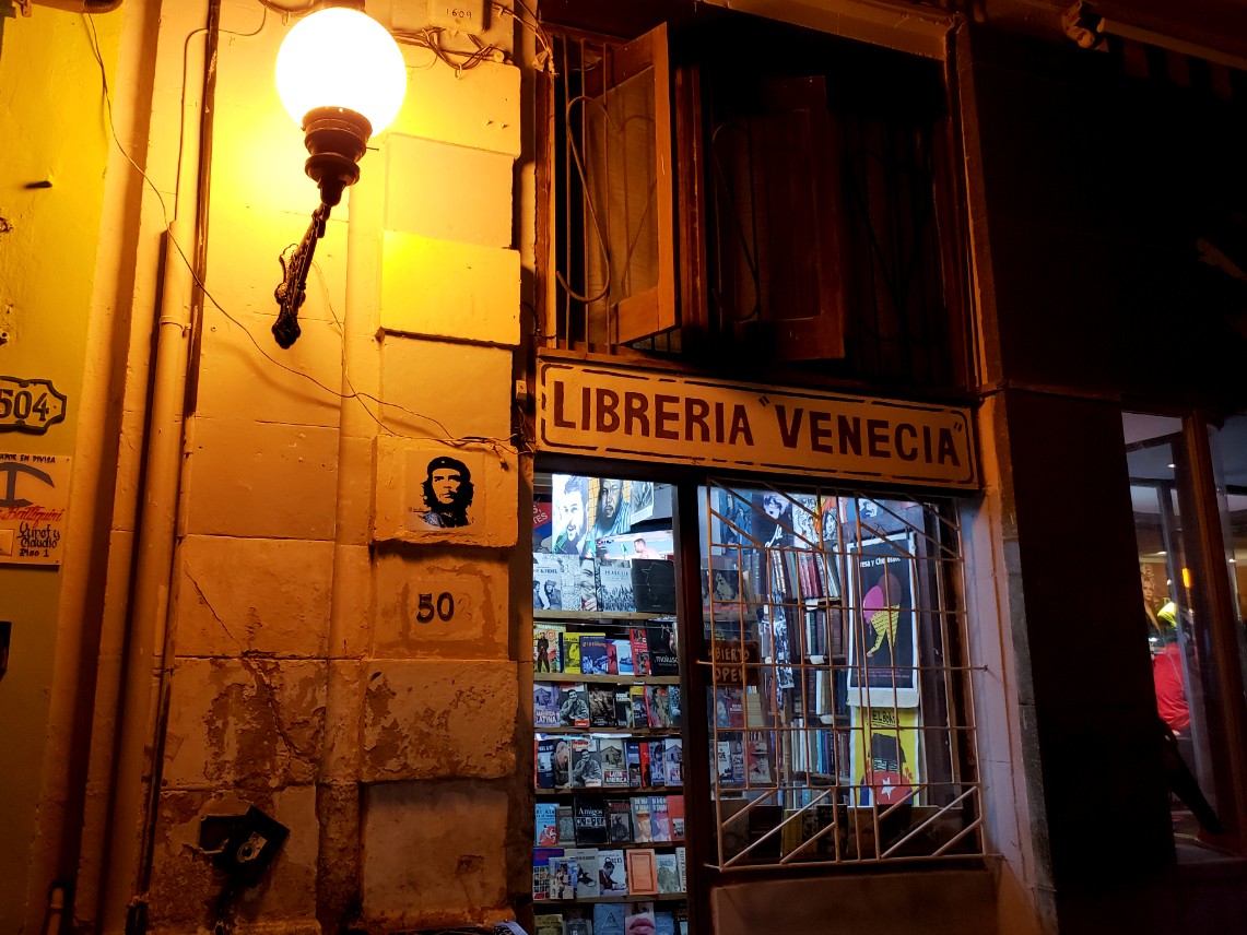 An old bookstore on Obispo Street - street lamp on due to night time.