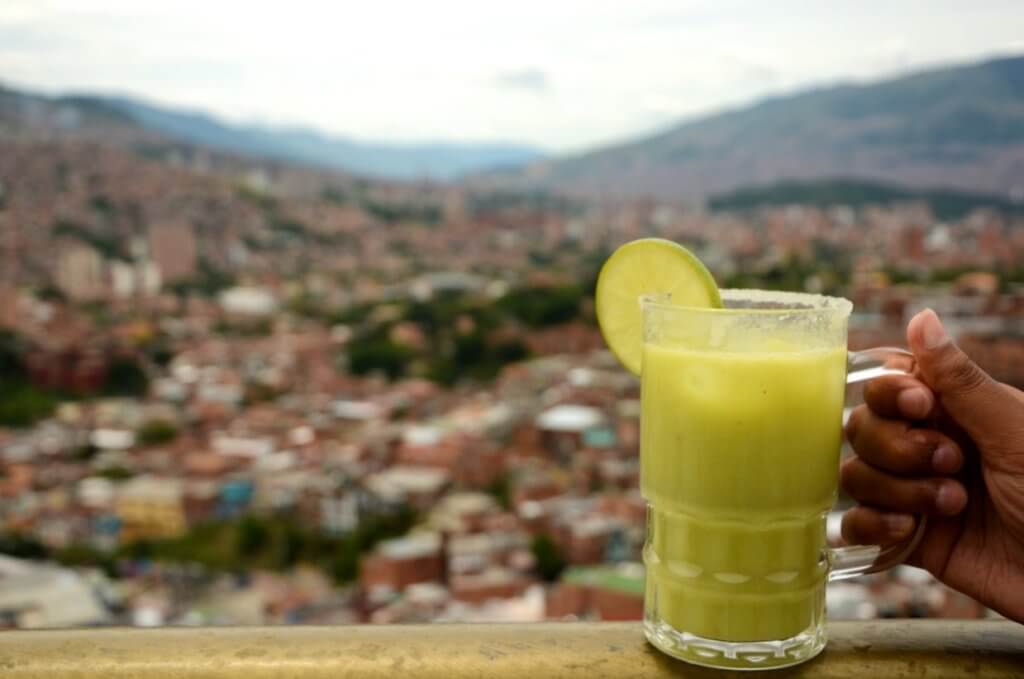 Medellin city view from Comuna 13, avocado shake in the foreground.