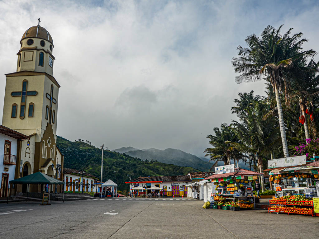 Central Plaza, fruit stalls and the town church in Salento, Colombia