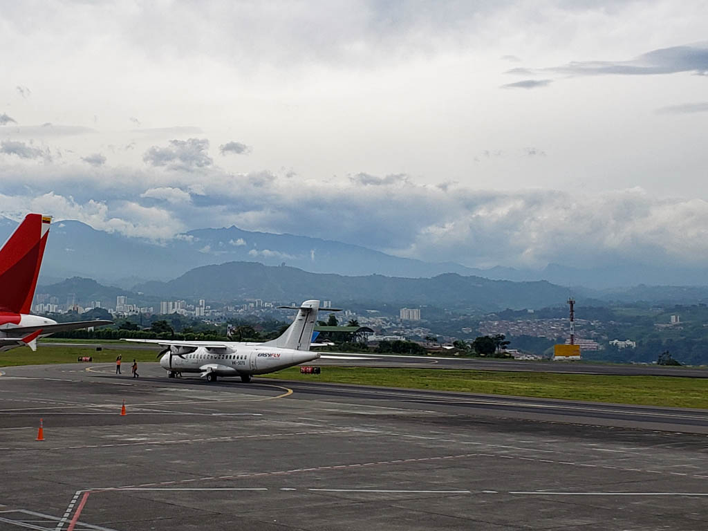 One white plane standing on the runway at Pereira airport, nearest airport to Salento.