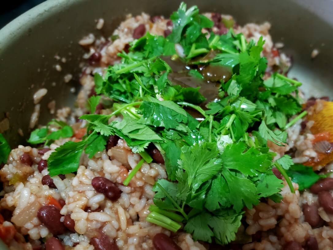 Salsa Lizano and cilantro added to rice and beans - Gallo Pinto in the making