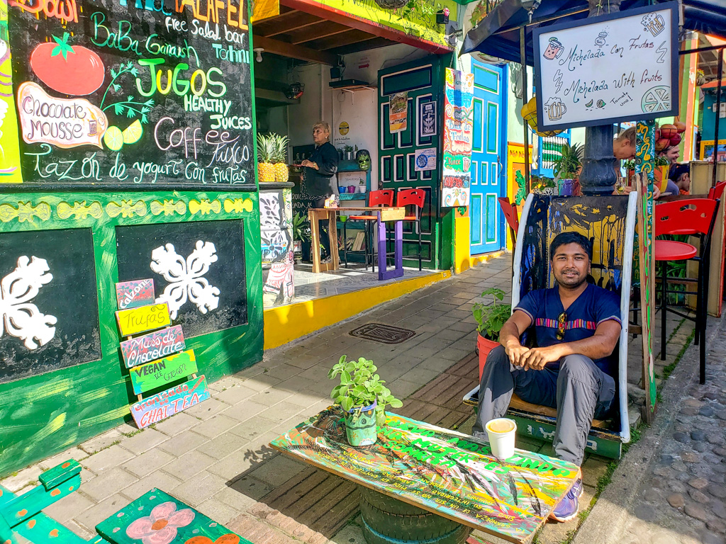 Indranil, chilling at a cafe in Guatape. End your Guatape day tour with a refreshing drink.