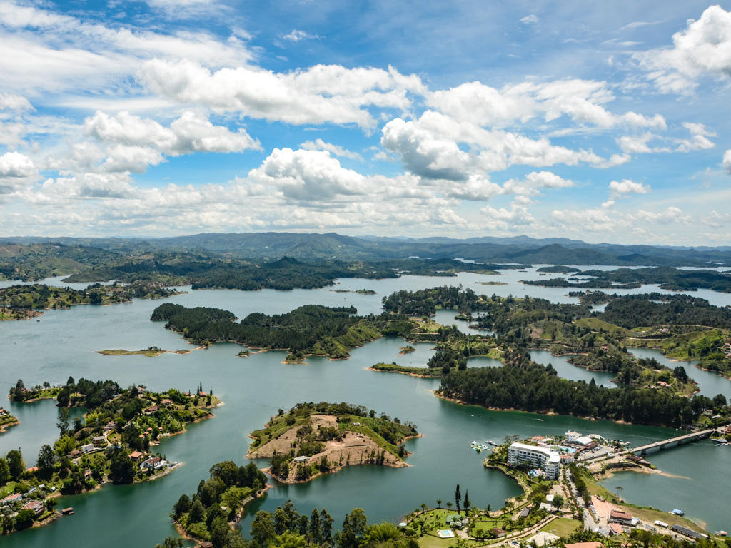Small green islands in the blue lake. View from El Peñón de Guatape. The views are totally worth the Guatape day tour.