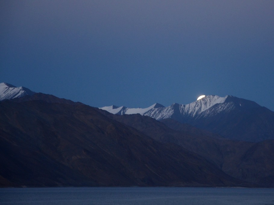 A glimpse of super moon rising over the Himalayan mountains, at Pangong lake