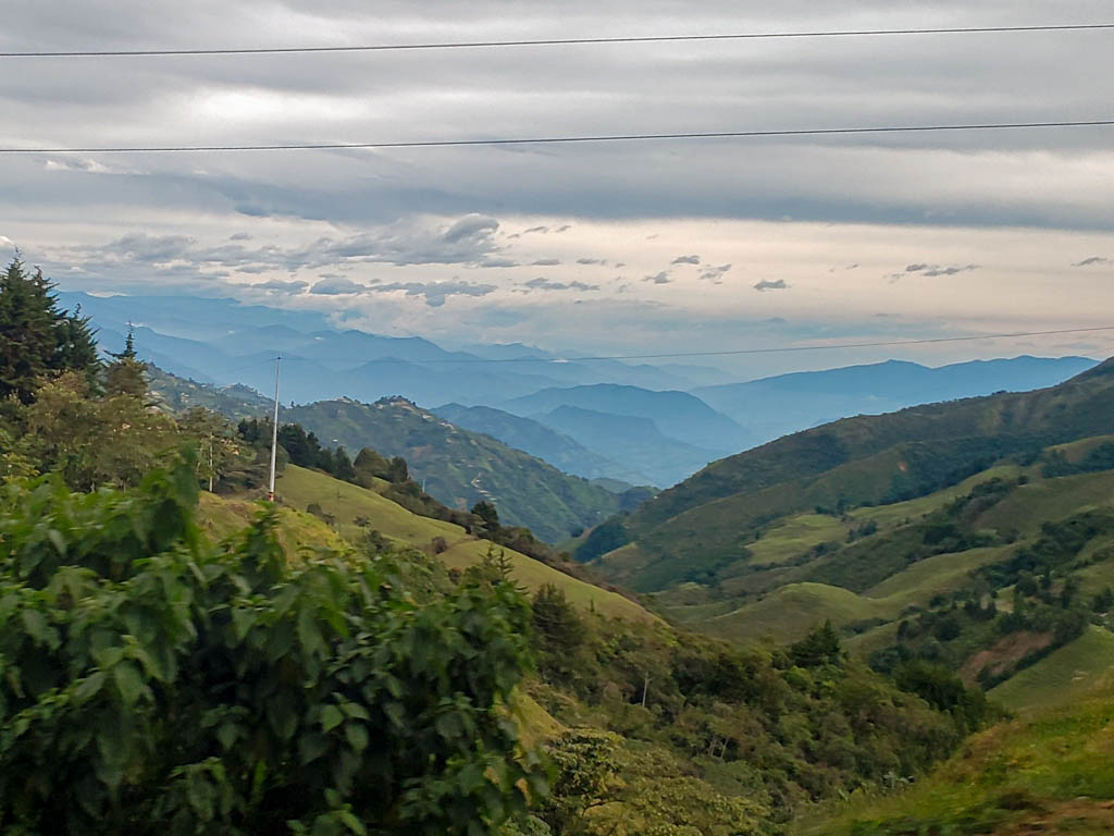 Colombian countryside, beautiful views of green mountains and valleys. This keeps you entertained during the journey by direct bus from Salento to Medellin.