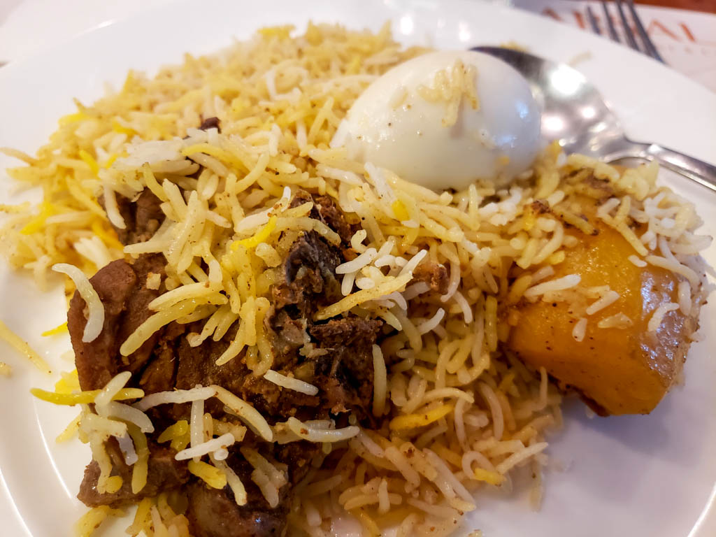 Mutton biryani - rice with spices, mutton, boiled egg and a piece of potato