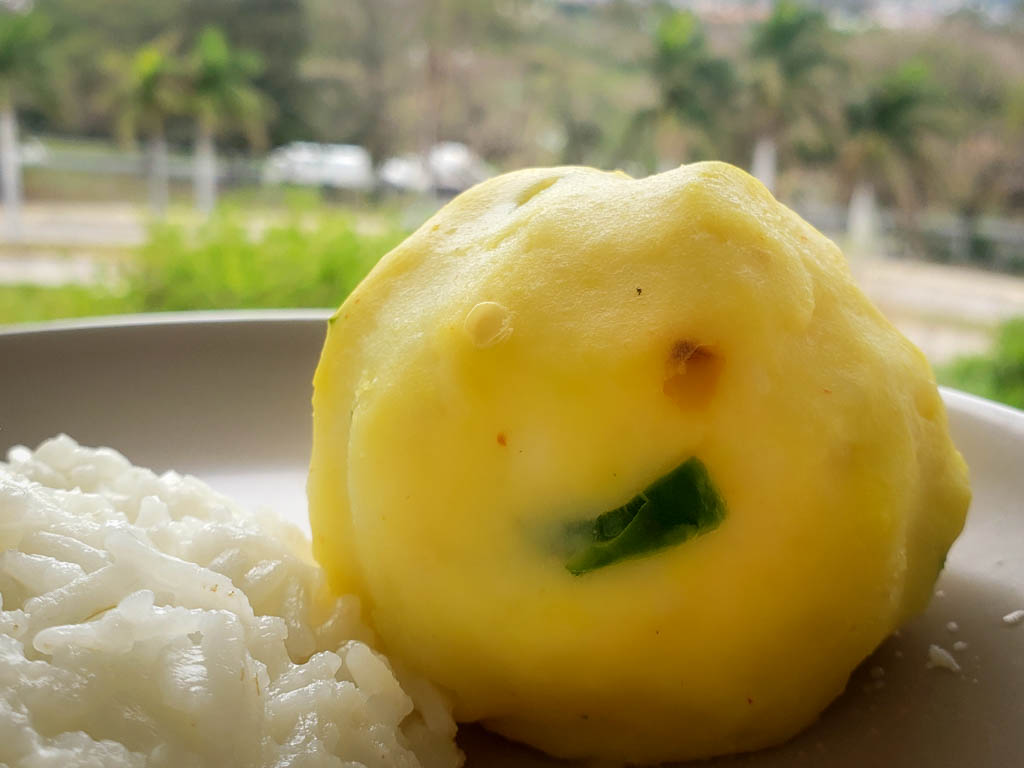 A round ball of mashed potato, served with white rice. A simple meal that complies with a lacto-ovo vegetarian meal plan.
