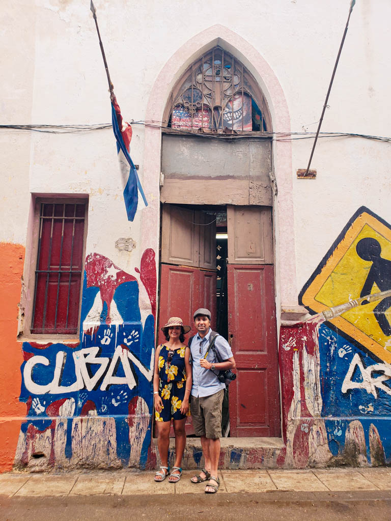 We, happy to be in Cuba :-)
On a random street, standing against a wall painted with splashes of Cuban color. Getting Cuba visa for Indians is not really difficult. You just need to buy the Cuba Tourist Card.