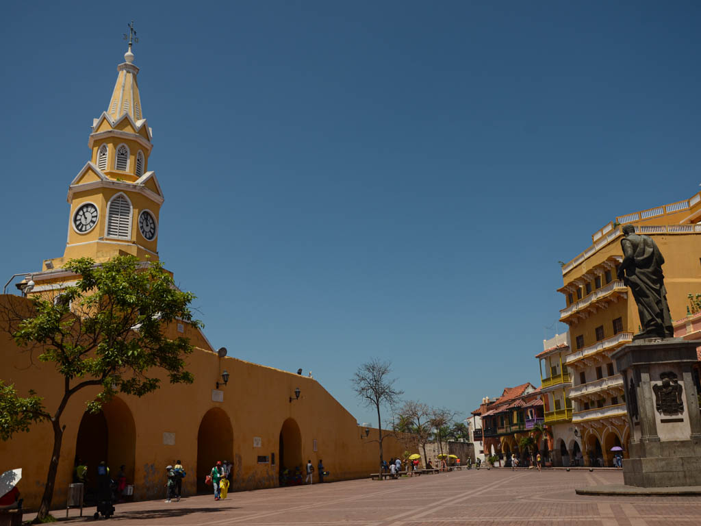 Yellow colored clock tower at the entrance of walled city of Cartagena.