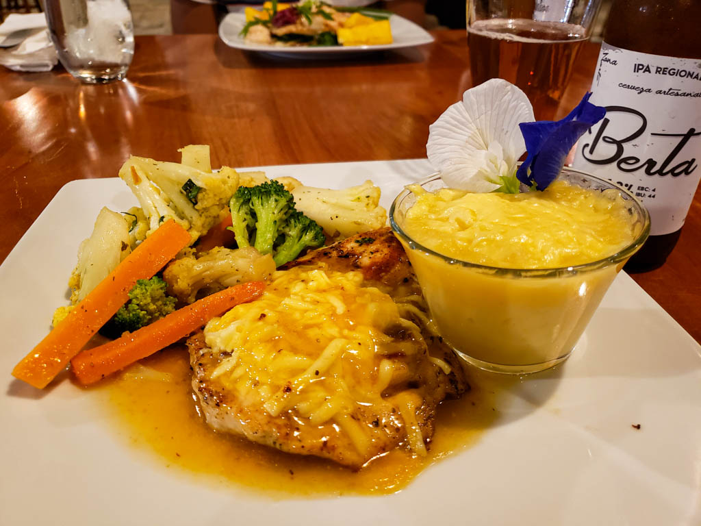 Basil Filled Chicken in Passion Fruit Sauce with locally brewed beer Berta served in Ecotermales Hot Springs, La Fortuna, Costa Rica