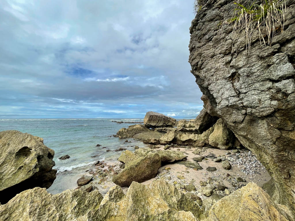Playa Cuevas near Malpais Costa Rica. Rocks framing the view of blue ocean and blue sky.