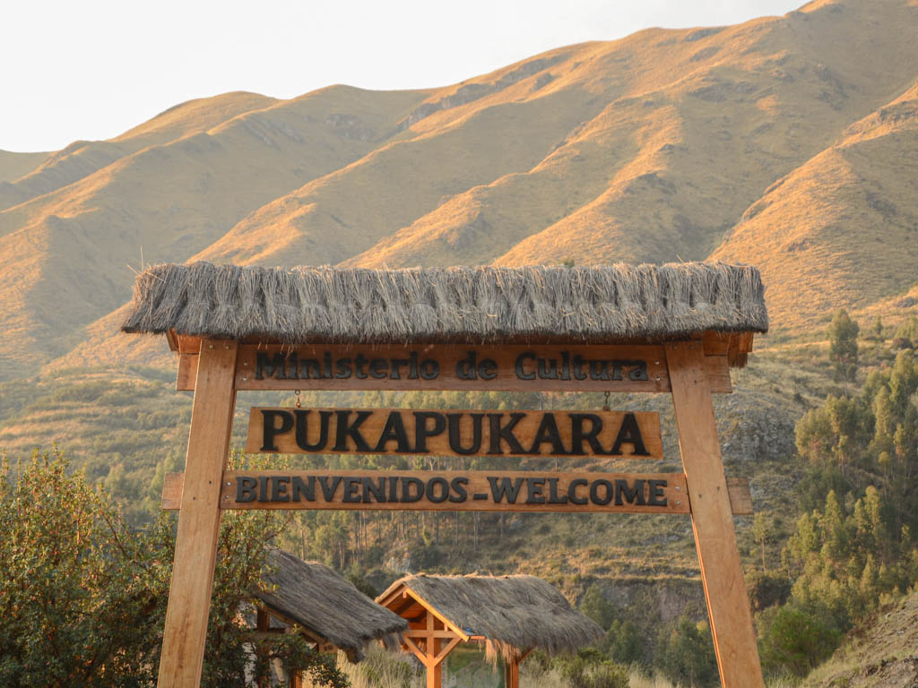 Golden hour light at the Welcome board at Puka Pukara entrance near Cusco.