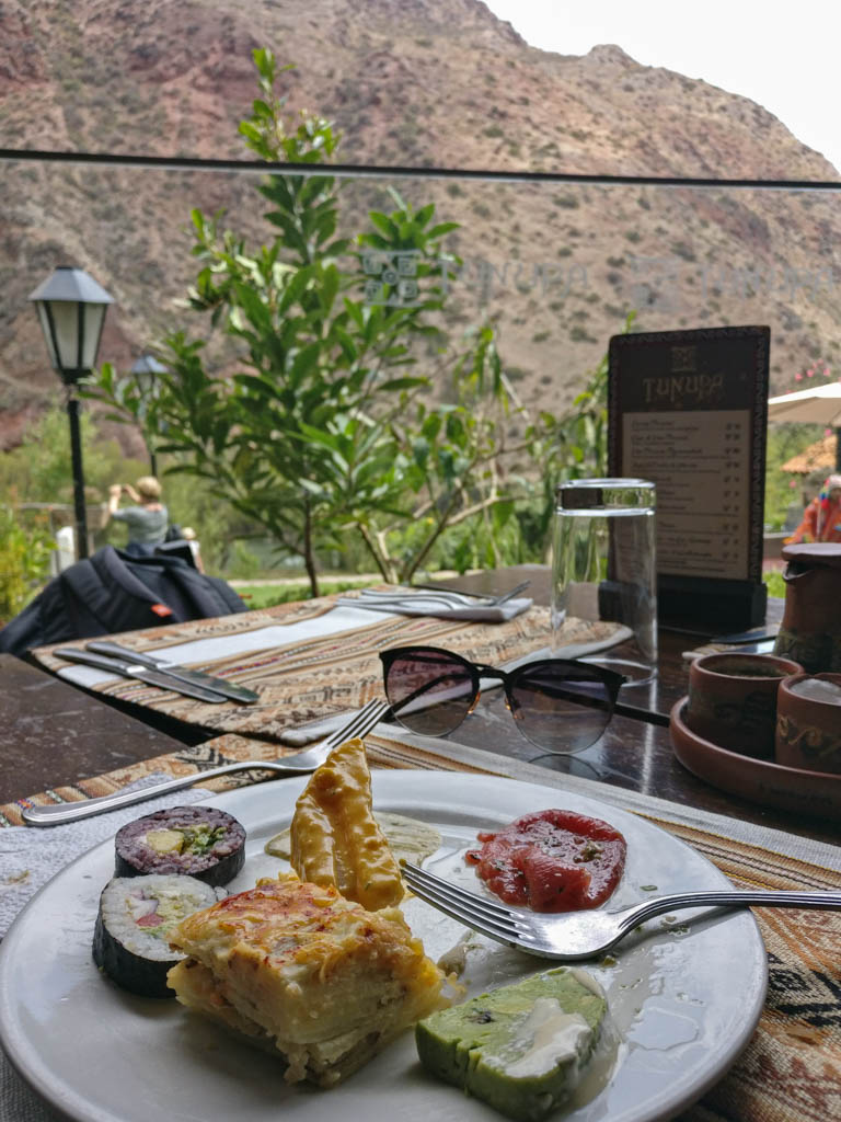 Lunch plate filled with different small snacks. Urubamba river view in the front.