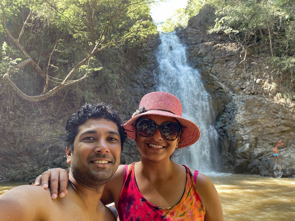 A man and a woman in front of the pool of the lower Montezuma Waterfall