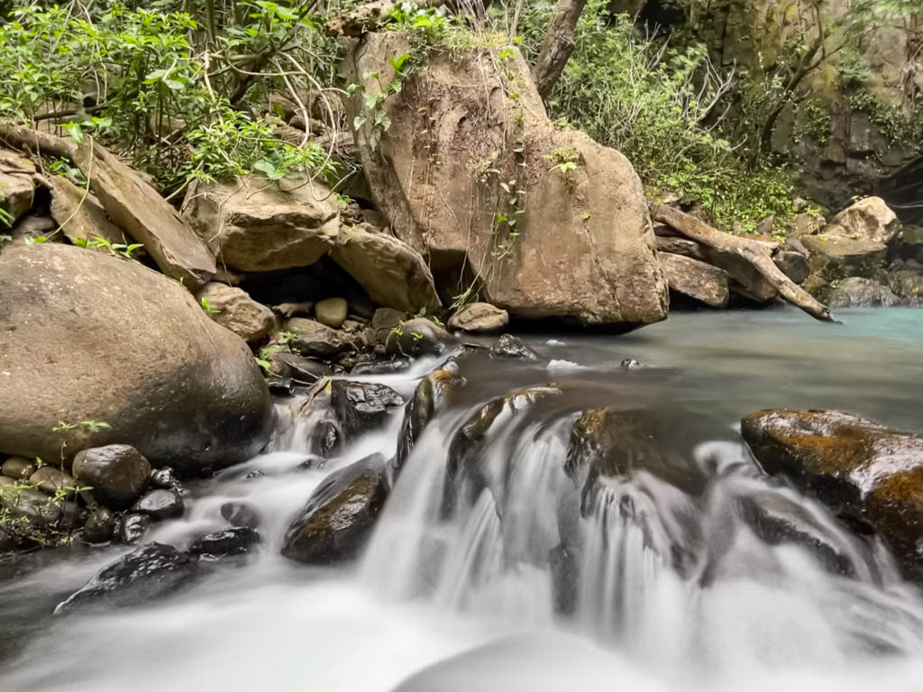 Long exposure shot of the rocky bend where the water from La Cangreja continues to flow as the river.