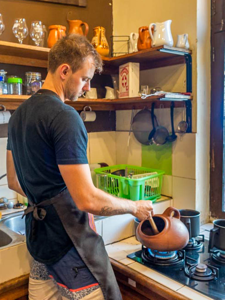 A man working in the kitchen to make chocolate. Chocolate making is one of the best things to do in Lima, Peru.