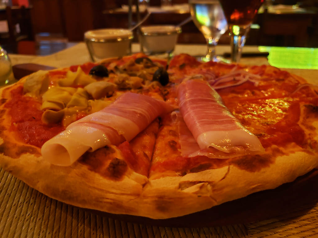 A close-up shot of wood fired pizza with seafood toppings, at Bon Apetit, a fine dining restaurant in Monteverde.