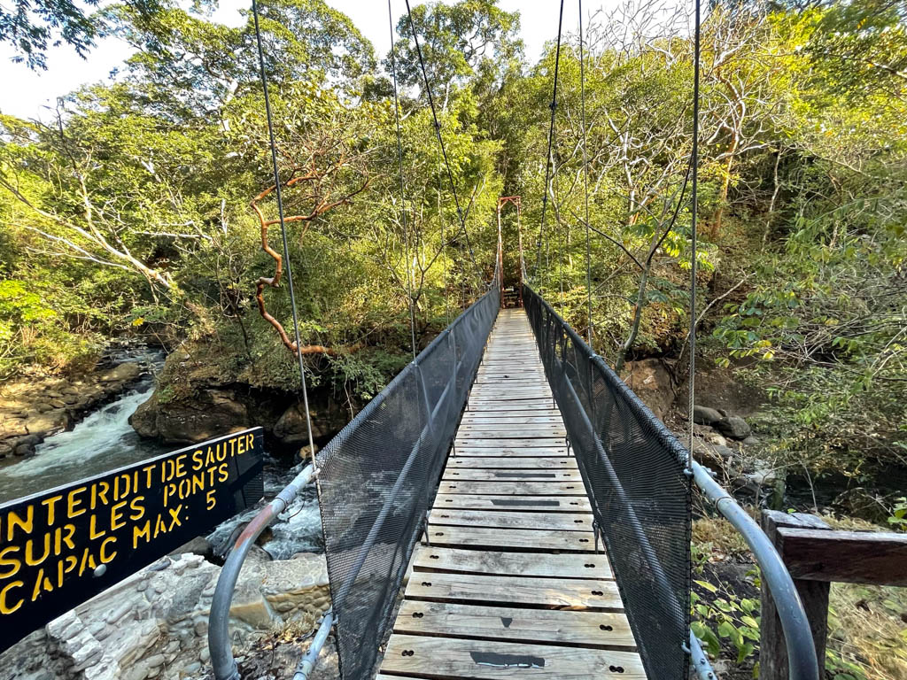 Hanging bridge to Rio Negro Hot Springs. Tropical dry forest greenery in the background.