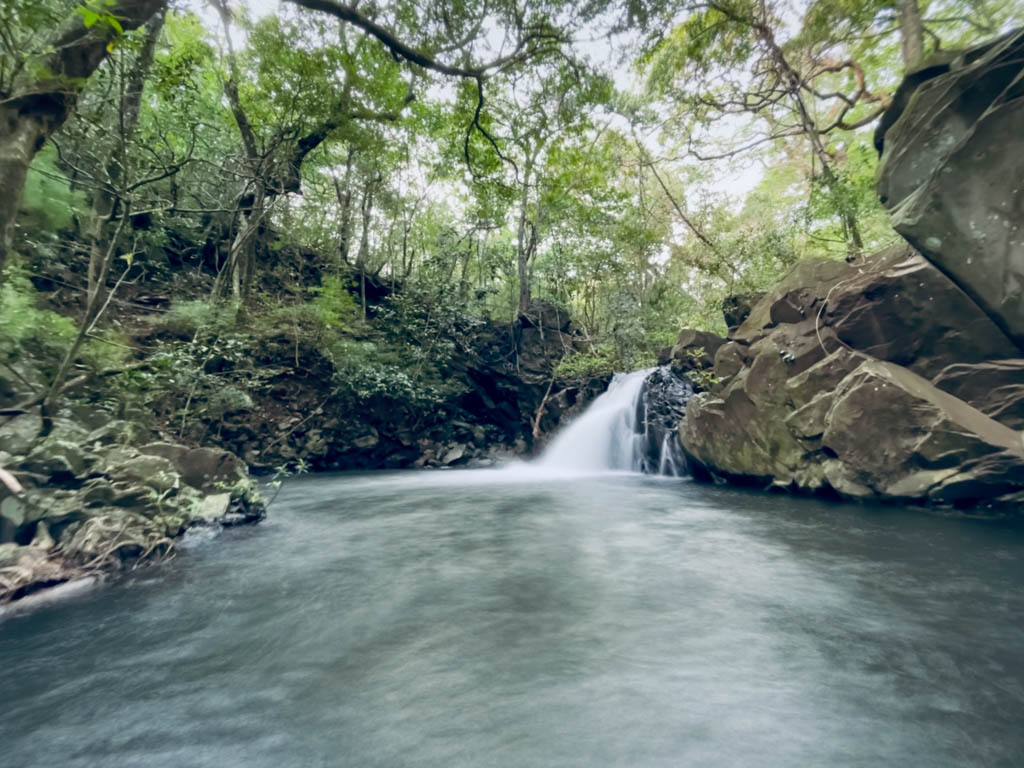 The first waterfall on the Rio Negro waterfalls trail. A small waterfall pouring into a large natural pool.
