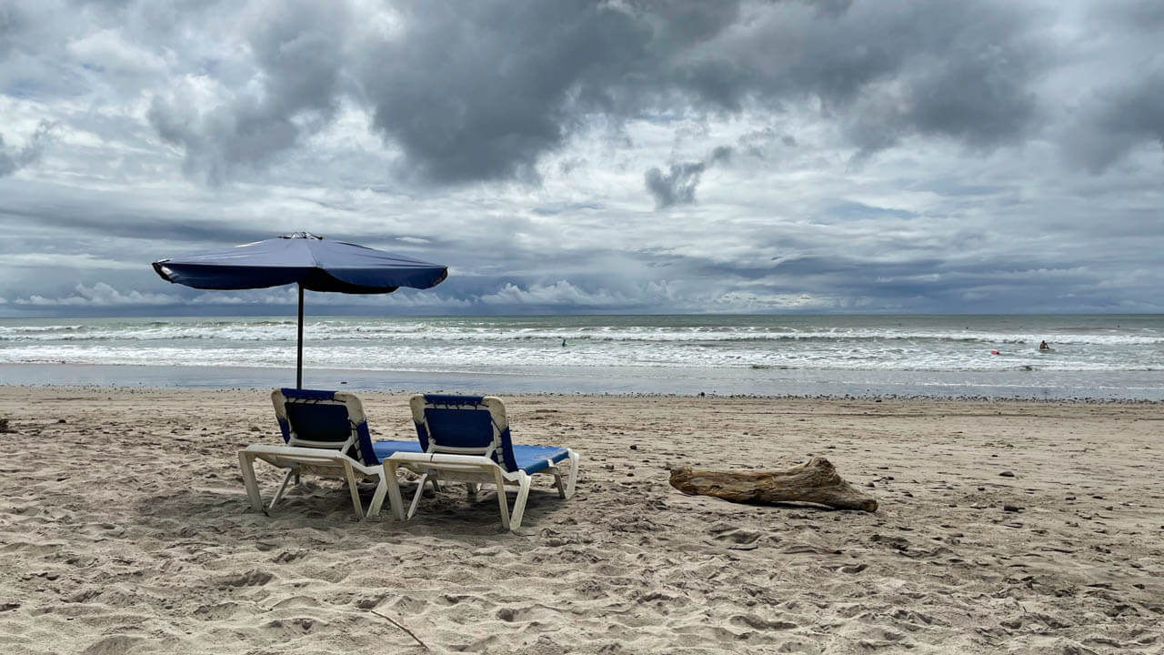 Blue sunbeds and umbrella at Playa Carmen Costa Rica.