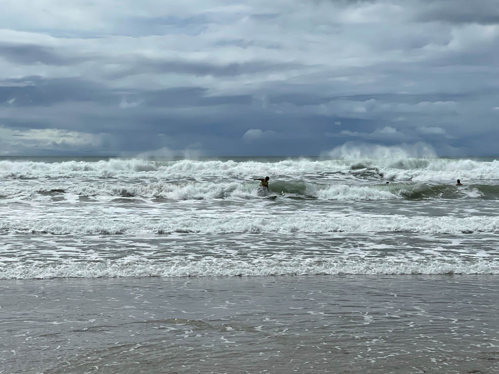 Surfers riding the waves at Pacific.