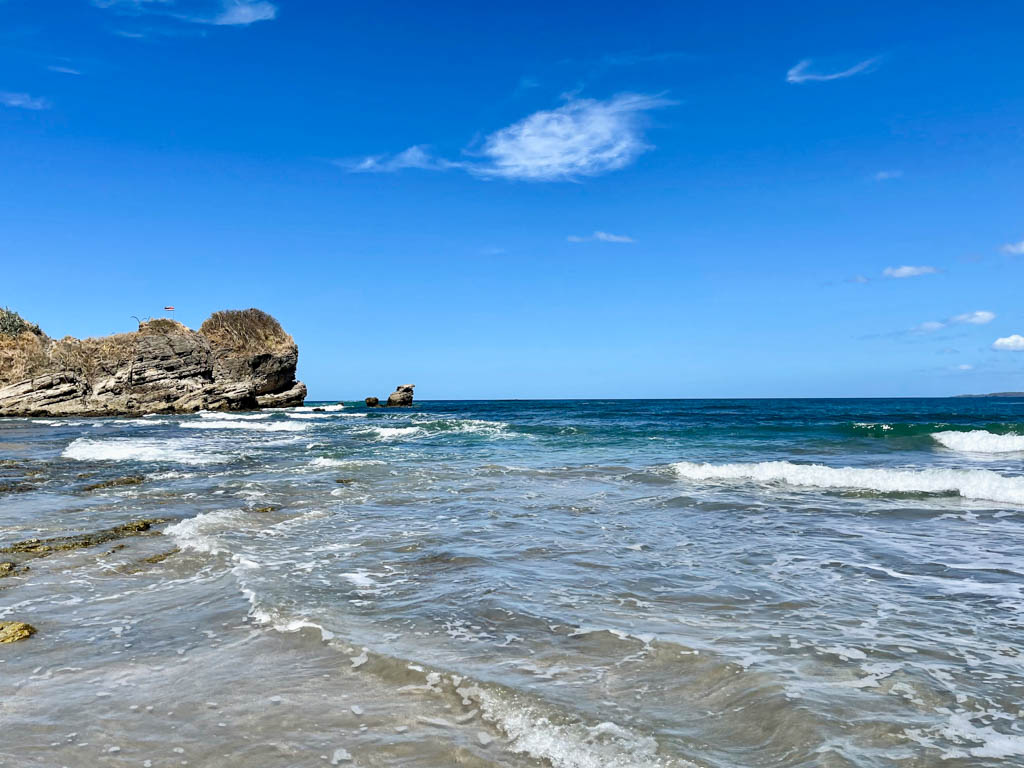 Playa Pelada: View of Pacific Ocean with a cliff in the left side background.