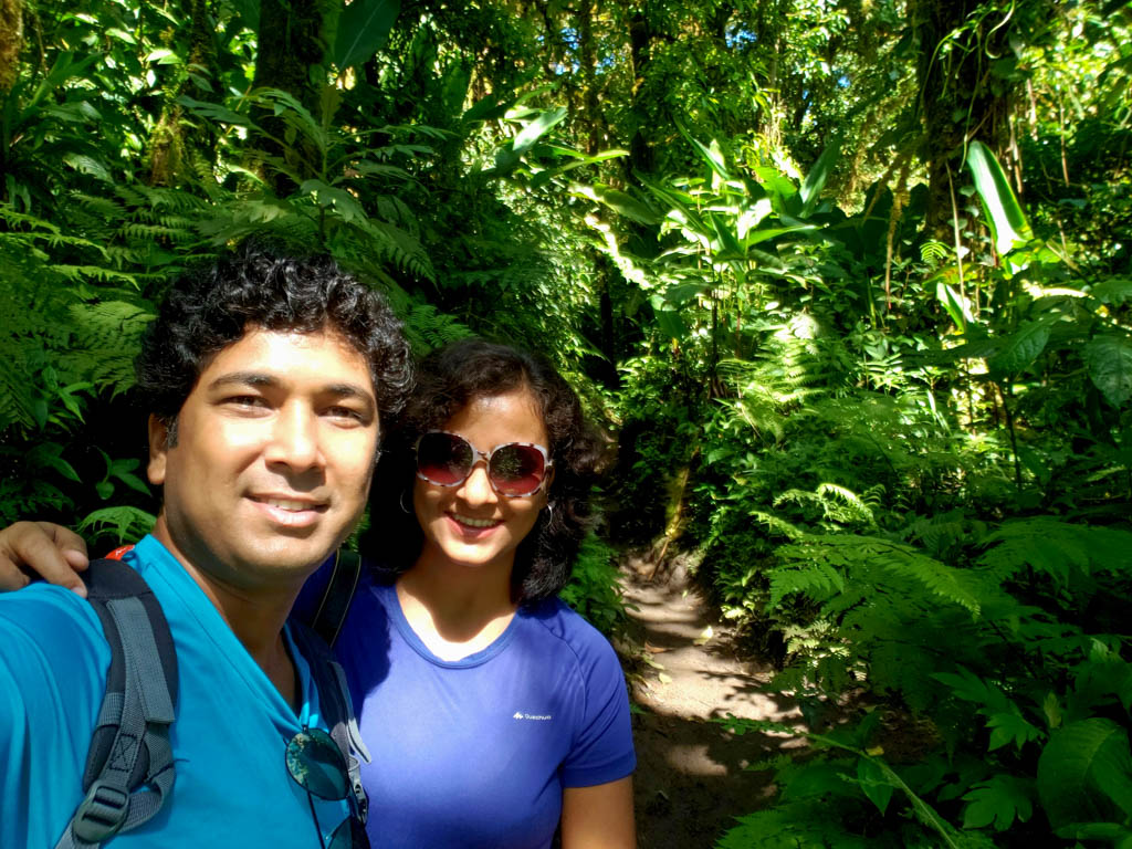 Couple, posing for a selfie, on one of the trails of Santa Elena Reserve in Monteverde.