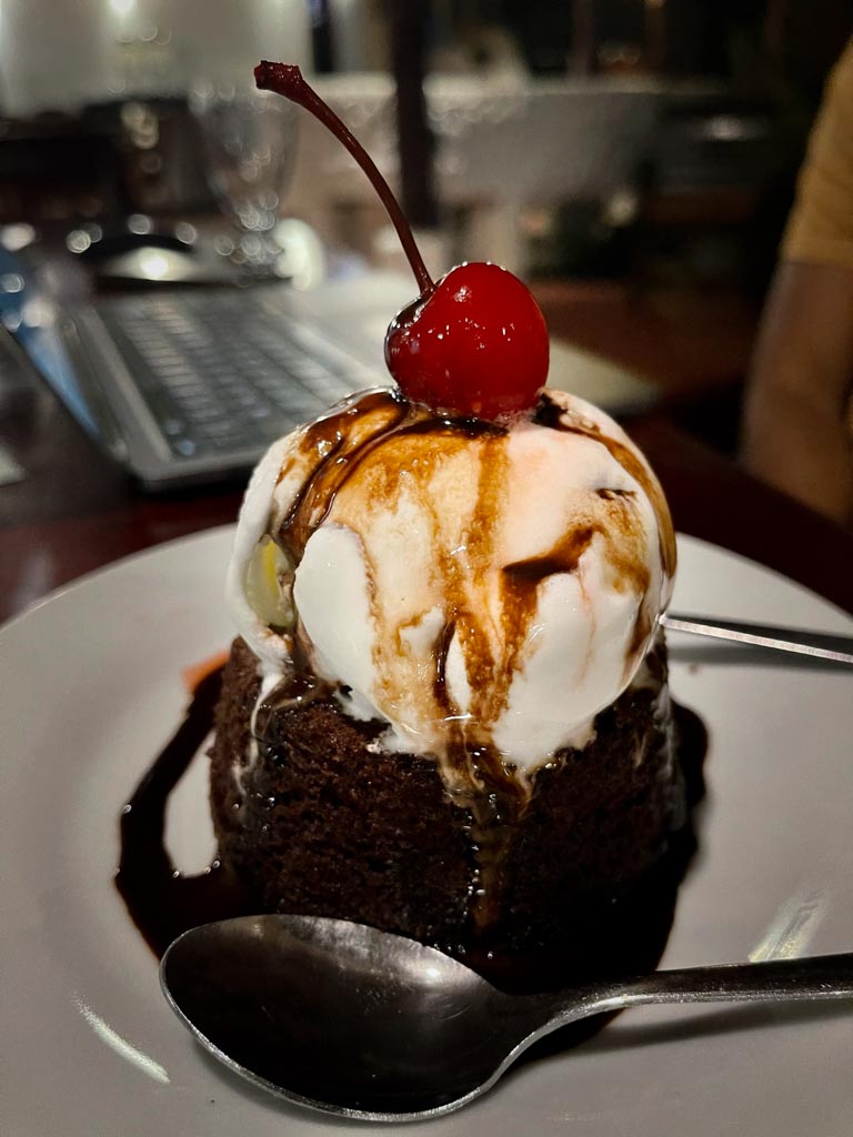 Brownie with ice-cream with a cherry on top.