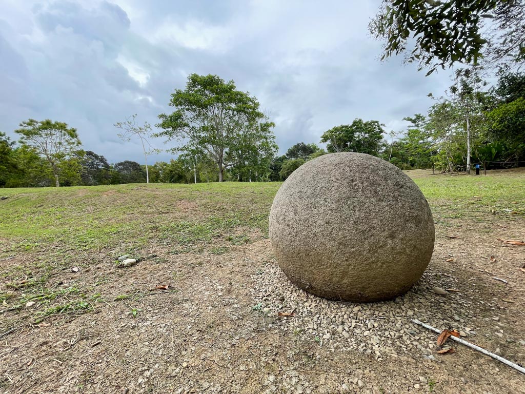 A large Stone Sphere with the Mound area behind.