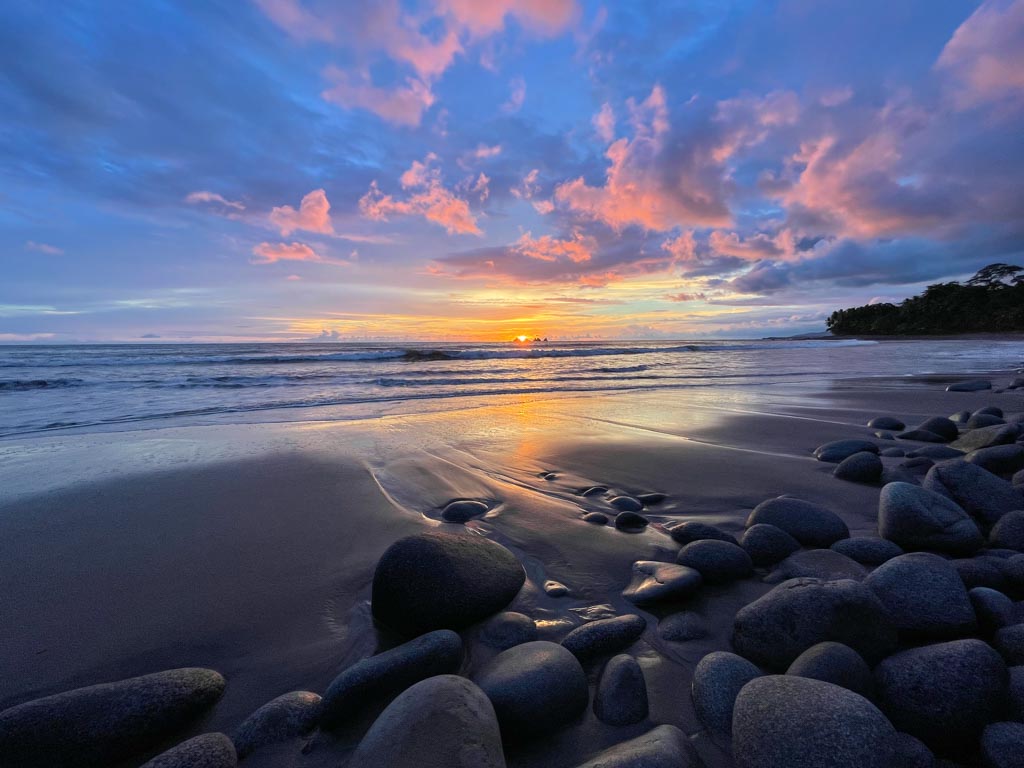 Light waves, stunning colors of sky and beach rocks.