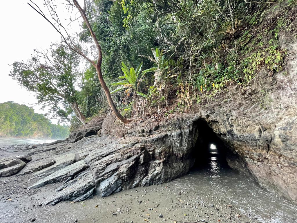 A hollow cave inside a cliff on the beach.