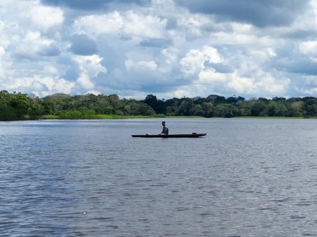 A man riding a boat in the Colombian Amazon.