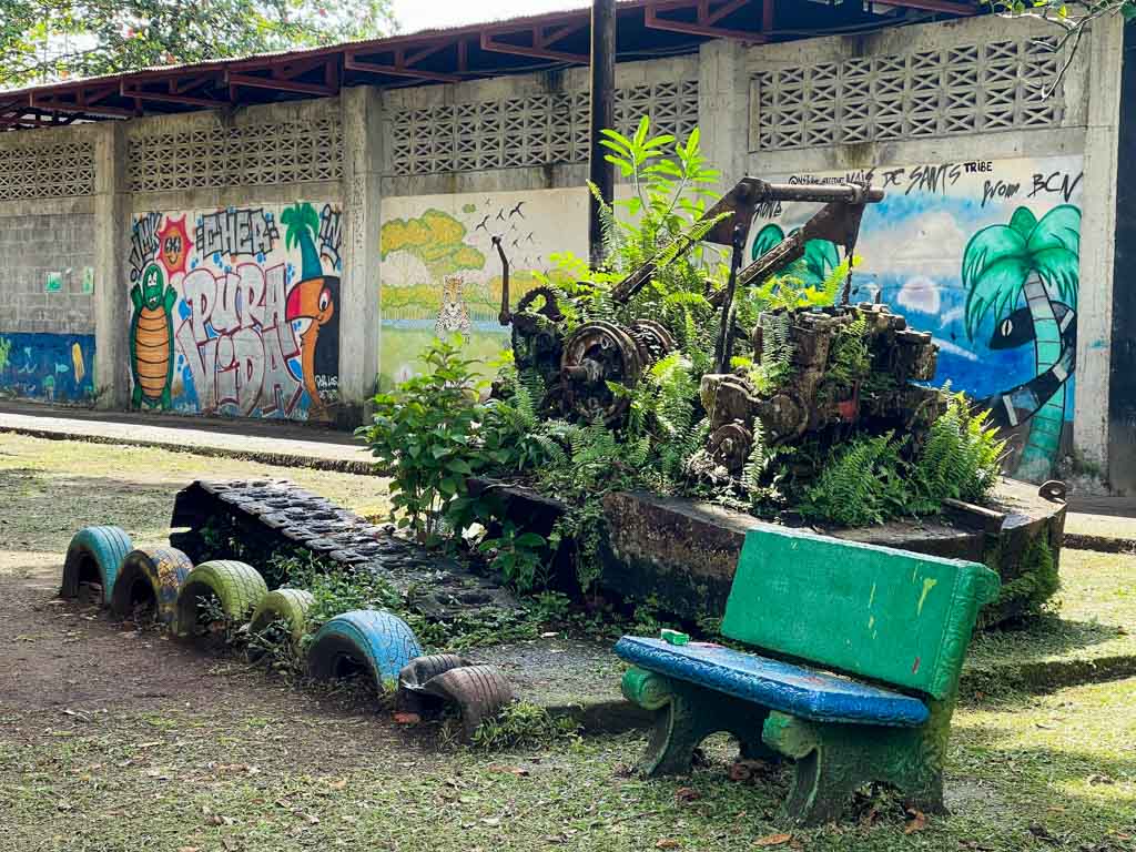 Town center decor of Tortuguero, Costa Rica: The discarded logging machines and colorful wall graffiti being the highlights.