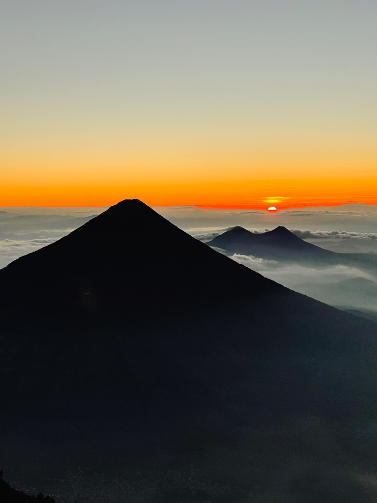 As seen from Acatenango volcano summit, sunrise with Agua volcano in the foreground.