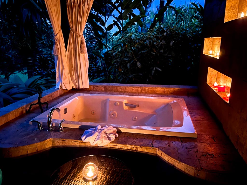 A romantic setting at Lomas del Volcan hotel room in La Fortuna. Candle light, rain forest and hot tub.