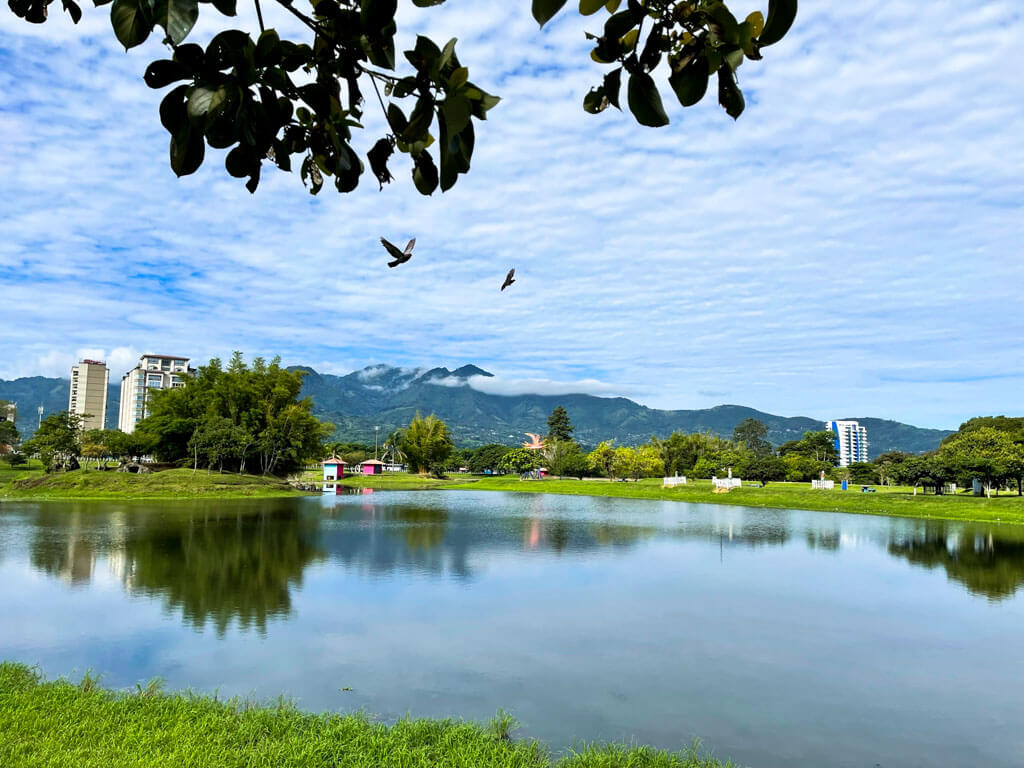 Lake at La Sabana Park in San Jose City in Costa Rica, with backdrop of green mountains.