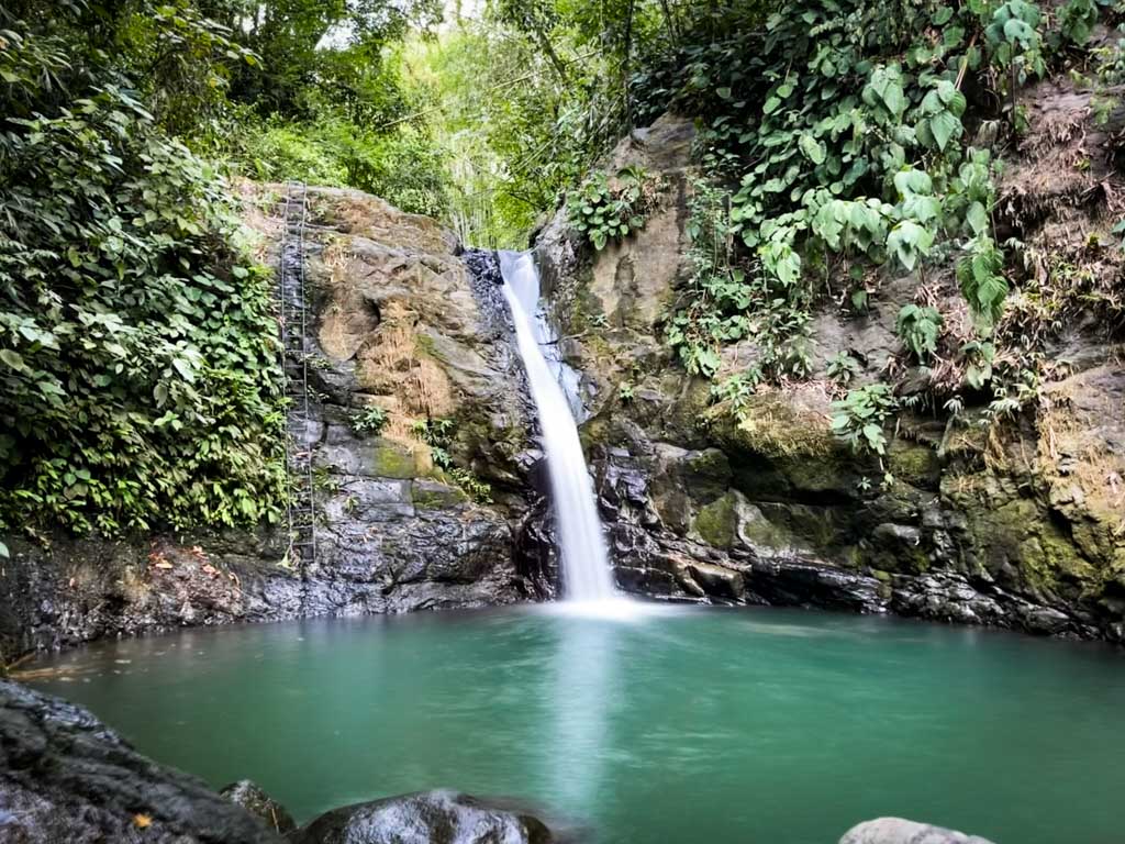 Uvita waterfall surrounded by lush tropical forest of Costa Rica.