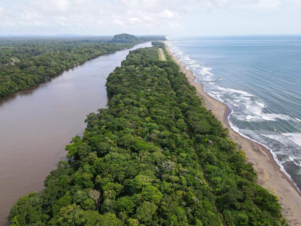An aerial view of Tortuguero, sandwiched between the river and the Caribbean Sea.