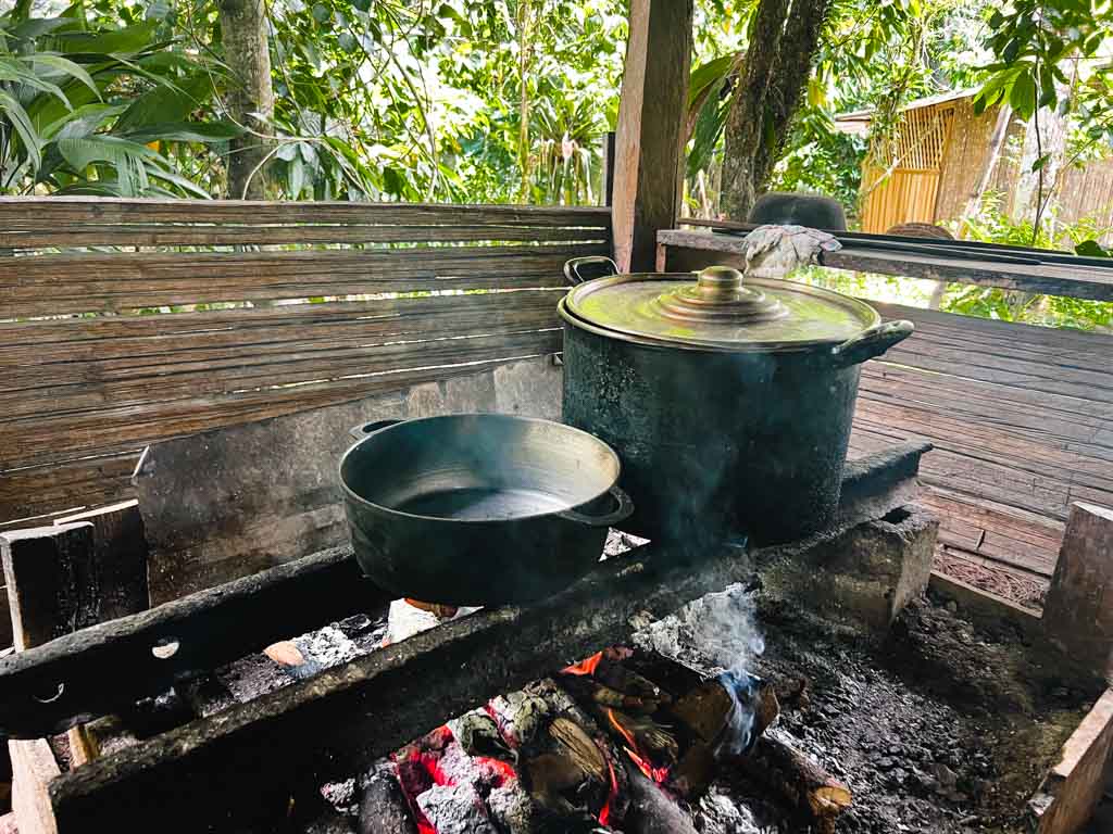 Cacao beans being roasted in traditional style, in aluminum vessels on wood fire. Chocolate Tour is one of the things to do in Puerto Vejo del Talamanca.