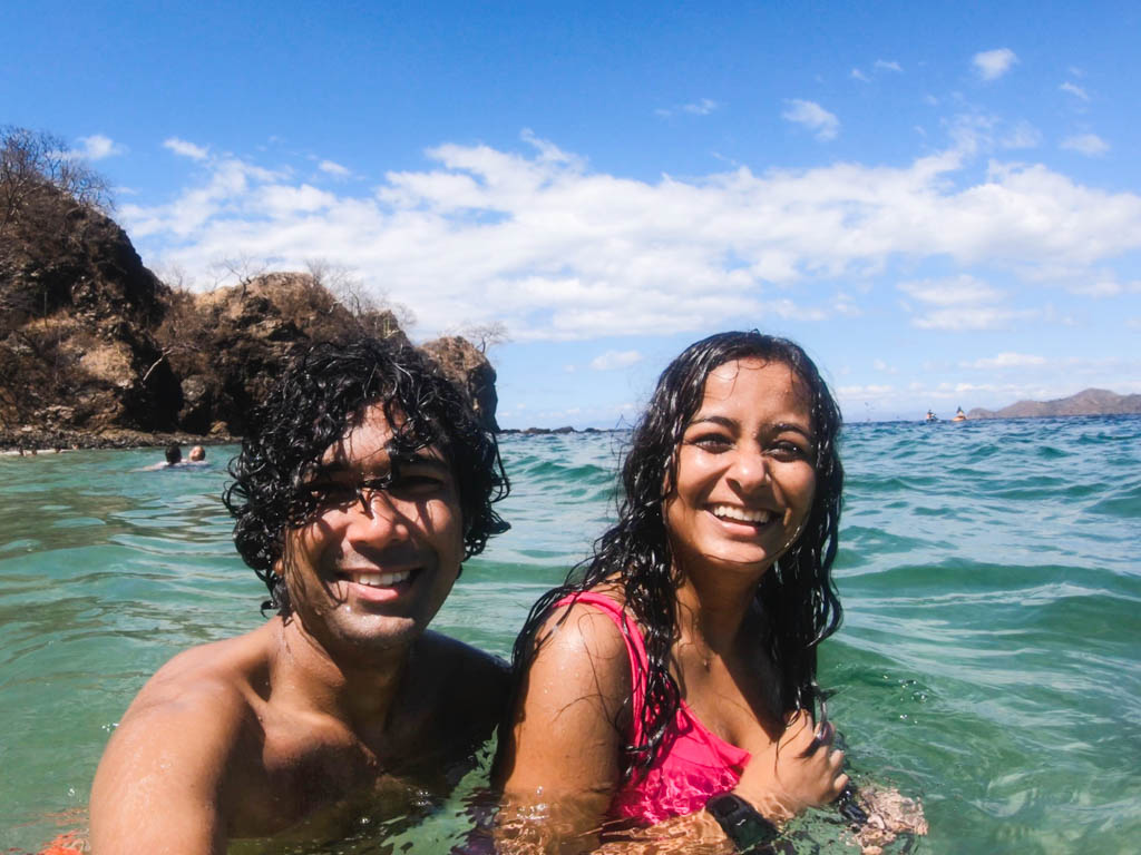 An Indian couple swimming in the ocean at Playa La Penca, a beach near Playa del Coco in Costa Rica.