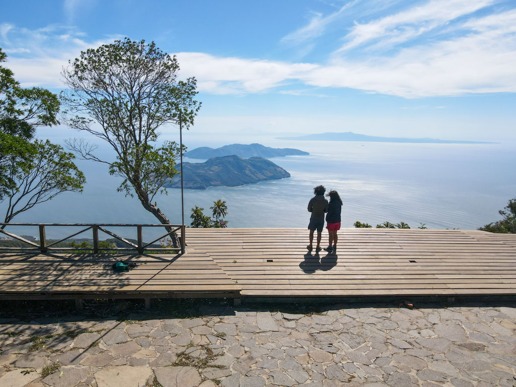 Drone shot of a couple standing on the viewing platform at Conchagua Volcano.
