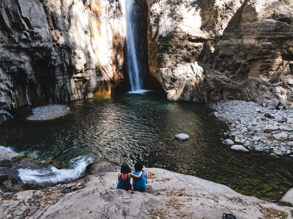 A couple enjoying the views of Tamanique waterfalls in El Salvador.