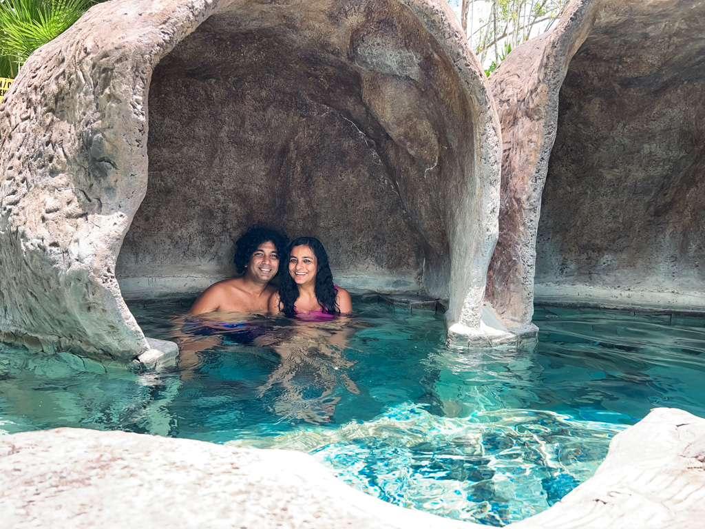 A man and woman in a hot spring cave in Los Lagos Resort.