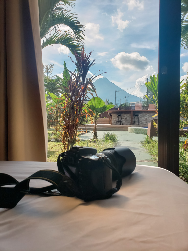 Camera on the bed of a Hotel Room with view of the Arenal Volcano.