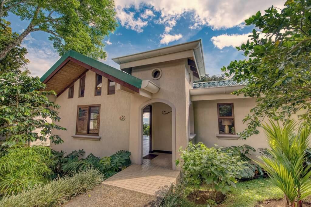A Villa in Buena Vista Chic Hotel near SJO Airport Costa Rica, surrounded by garden.